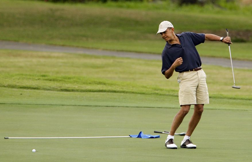 **FILE** President Obama watches the ball after making a putt on the ninth green during his golf match at the Mid-Pacific County Club in Kailua, Hawaii, on Dec. 31, 2009. (Associated Press)