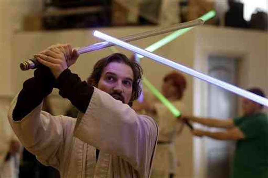 In San Francisco, Golden Gate Knights instructor Alain Block teaches a combat choreography class for Jedis-in-training with their weapon of choice: the light saber. (AP Photo/Jeff Chiu)