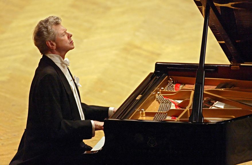 American pianist Van Cliburn performs in Moscow on Sept. 21, 2004, in a concert dedicated to the memory of the victims of the Beslan school massacre. (AP Photo/Sergey Ponomarev)