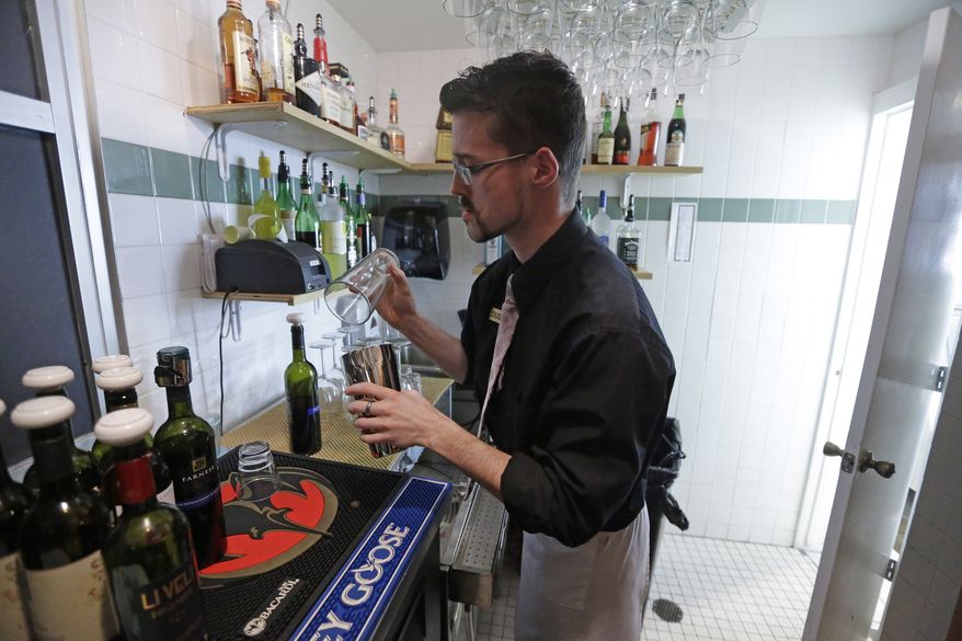 Dustin Humes, manager of the Vivace restaurant in Salt Lake City, fixes a drink out of the view of patrons on Tuesday, Feb. 26, 2013. (AP Photo/Rick Bowmer)