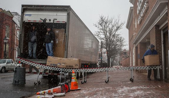 Truck workers for Ross department store, unload boxes of merchandise in the snow in Alexandria, Va., Wednesday, March 6, 2013. (Andrew S. Geraci/The Washington Times)
