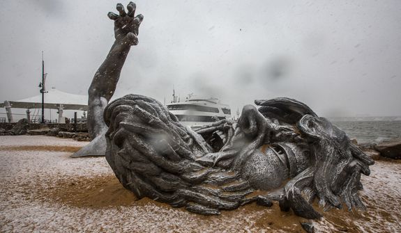 Light snow blankets 'The Awakening' sculpture, located at National Harbor in Washington, D.C., Wednesday, March 6, 2013. (Andrew S. Geraci/The Washington Times)