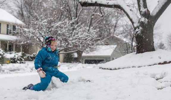 Reily Sweeney, 5, sits on her snowman during a snowball fight in a residential neighborhood, in Fairfax, VA., Wednesday, March 6, 2013.(Andrew S. Geraci/The Washington Times)