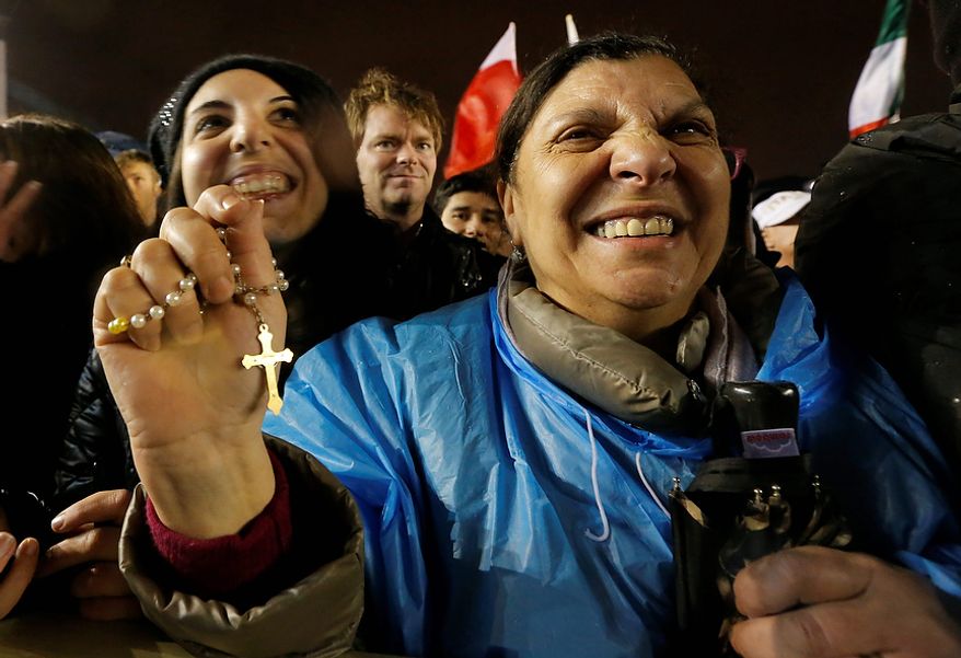 Crowds cheer after white smoke billowed from the chimney on the Sistine Chapel indicating that a new pope has been elected in St. Peter's Square at the Vatican, Wednesday, March 13, 2013. (AP Photo/Dmitry Lovetsky)
