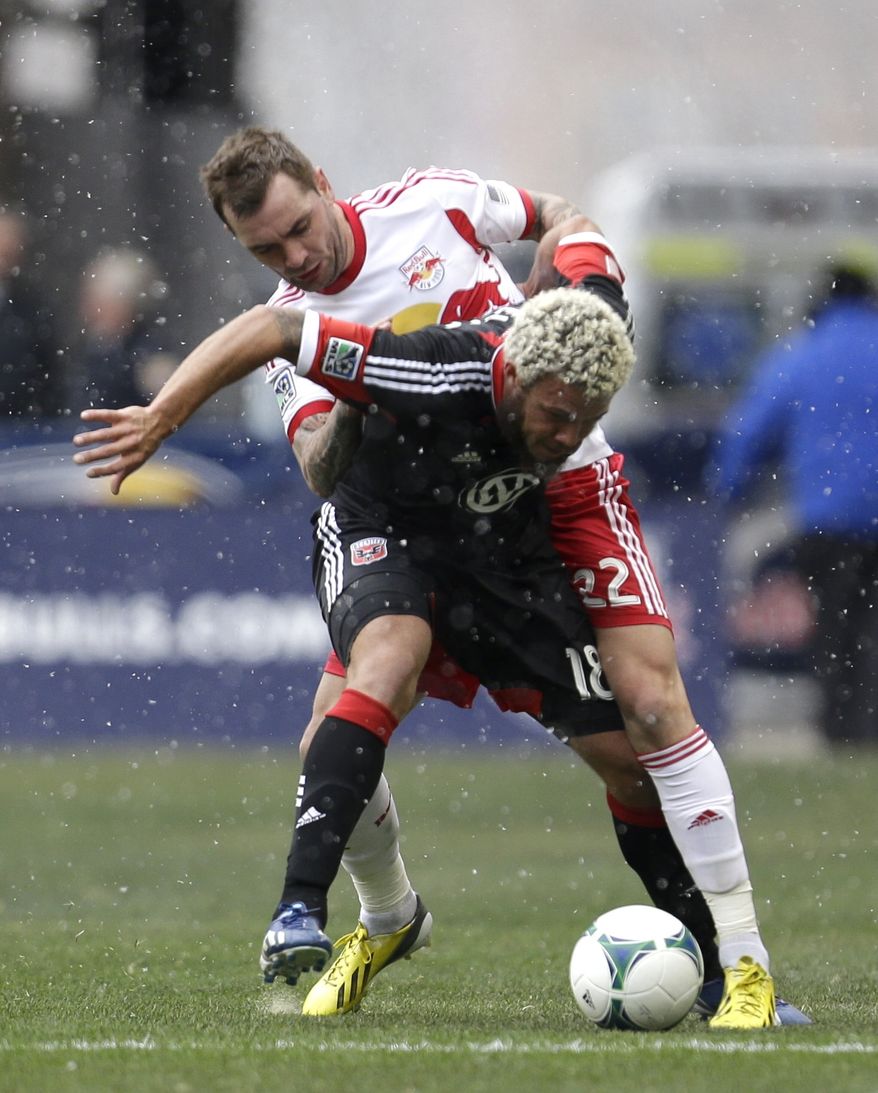 D.C. United midfielder Nick DeLeon, front, shields the ball from New York Red Bulls midfielder Jonny Steele during the first half of an MLS soccer game, Saturday, March 16, 2013, in Harrison, N.J. (AP Photo/Julio Cortez)