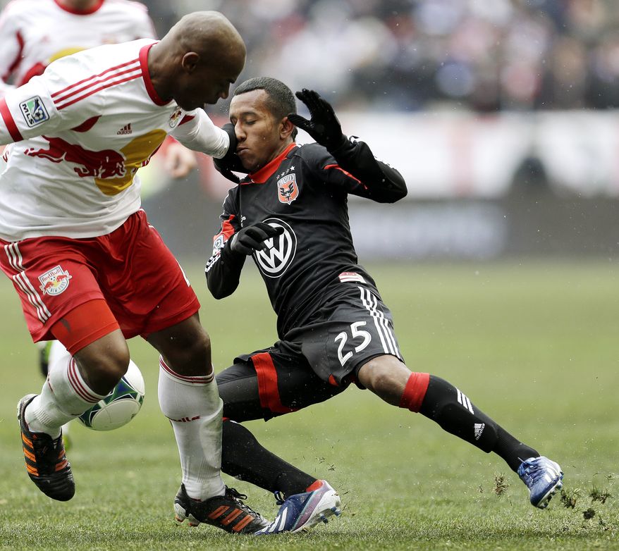 D.C. United midfielder Marcos Sanchez (25) gets a hand to the face by New York Red Bulls defender Jamison Olave during the second half of an MLS soccer match, Saturday, March 16, 2013, in Harrison, N.J. The teams tied 0-0. (AP Photo/Julio Cortez)