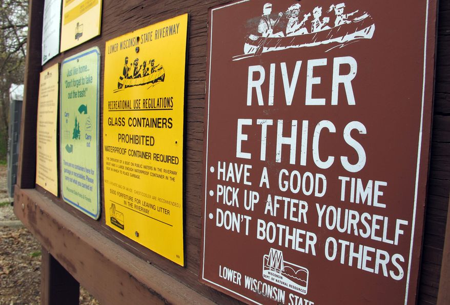 **FILE** Signs near a nude beach in Mazomanie, Wis., are seen here on April 13, 2012. (Associated Press)