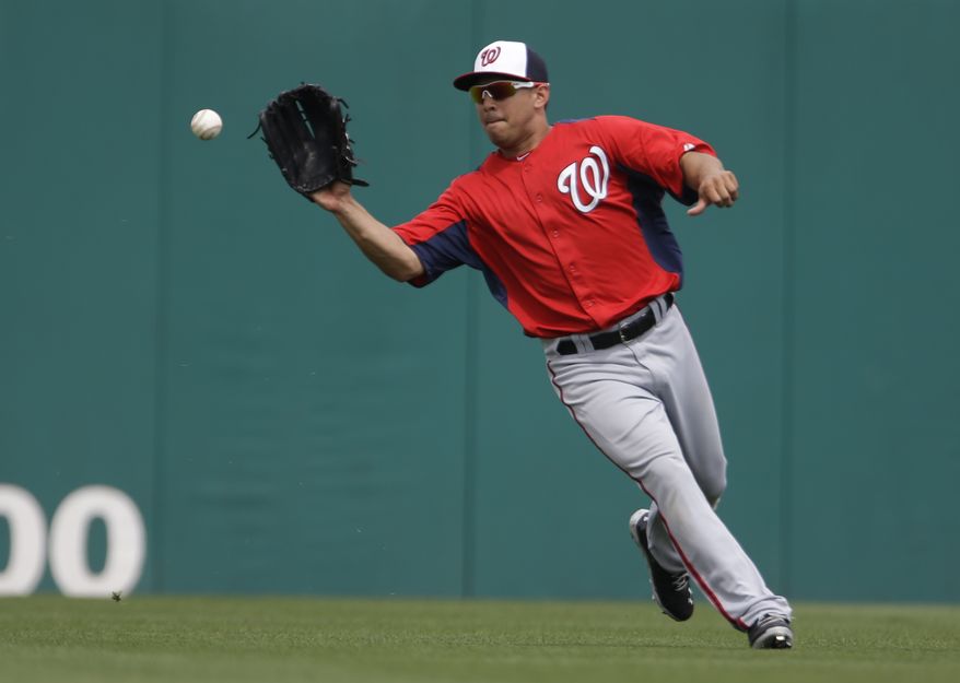 Washington Nationals center fielder Erik Komatsu handles the ball during the sixth inning of an exhibition spring training baseball game against the Miami Marlins Wednesday, March 20, 2013, in Jupiter, Fla. (AP Photo/Jeff Roberson)