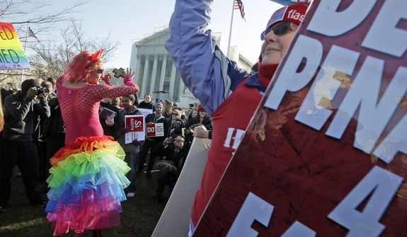 Qween Amar (left) from Orlando, Fla., dances March 26, 2013, by Margie Phelps (right), a member of the Westboro Baptist Church, outside the Supreme Court in Washington,where the court will hear arguments on California's voter approved ban on same-sex marriage, Proposition 8. (Associated Press)