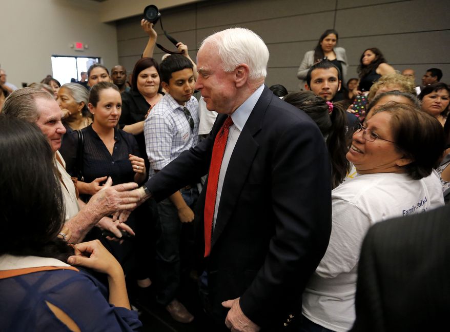 Sen. John McCain, Arizona Republican, greets participants after a town hall meeting on Monday, March 25, 2013, in Phoenix. (AP Photo/Matt York)