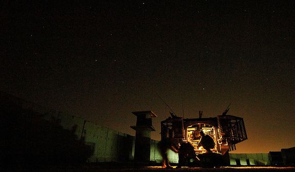 U.S. Army Soldiers try to pull an illumination flare from it's case before firing it over the city of Mosul, Iraq, June 1, 2006, with a 120mm mortar cannon. The illumination flares are fired will brighten the city to deter terrorist from planting improvised explosive devices. The Soldiers are from Headquarters and Headquarters Company, 1st Battalion, 17th Battalion Mortars, 172nd Stryker Brigade Combat Team. (U.S. Air Force photo by Tech. Sgt. Jeremy T. Lock)