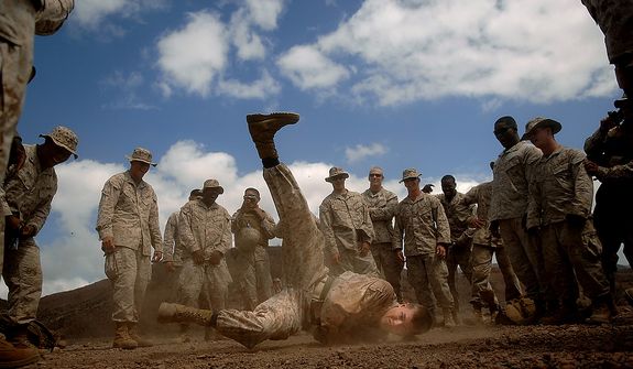 Lance Cpl. Brett Herman from the 3rd Low Altitude Air Defense Battalion, Camp Pendleton, Calif. break dances during some down time before moving to the next firing range in the Arta region of Djibouti on January 23, 2008. The Marines will be firing the M203 Grenade Launcher, AT-4 and throwing M67 Fragment Grenades for practice while deployed with the Combined Joint Task Force- Horn of Africa located at Camp Lemonier, Djibouti. (U.S. Air Force photo by Tech. Sgt. Jeremy T. Lock)