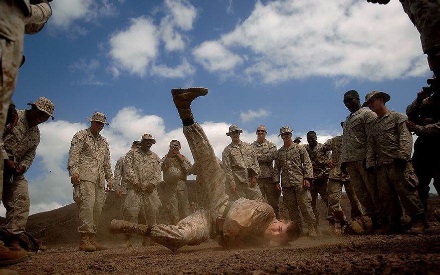 Lance Cpl. Brett Herman from the 3rd Low Altitude Air Defense Battalion, Camp Pendleton, Calif. break dances during some down time before moving to the next firing range in the Arta region of Djibouti on January 23, 2008. The Marines will be firing the M203 Grenade Launcher, AT-4 and throwing M67 Fragment Grenades for practice while deployed with the Combined Joint Task Force- Horn of Africa located at Camp Lemonier, Djibouti. (U.S. Air Force photo by Tech. Sgt. Jeremy T. Lock)