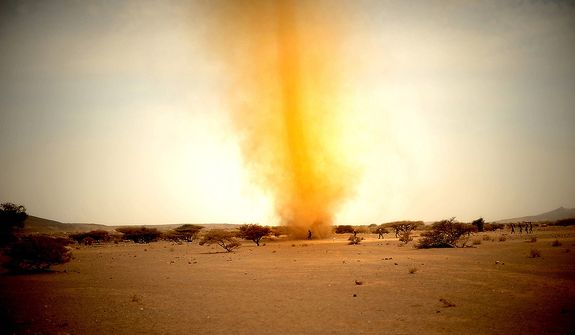 French soldiers chase down papers picked up by a small dust tornado that went right through their camp during a 10-day French Tactical Desert Survival Training Course on May 8, 2008 in the Djiboutian desert, Djibouti, Africa. (U.S. Air Force photo by Tech. Sgt. Jeremy T. Lock)