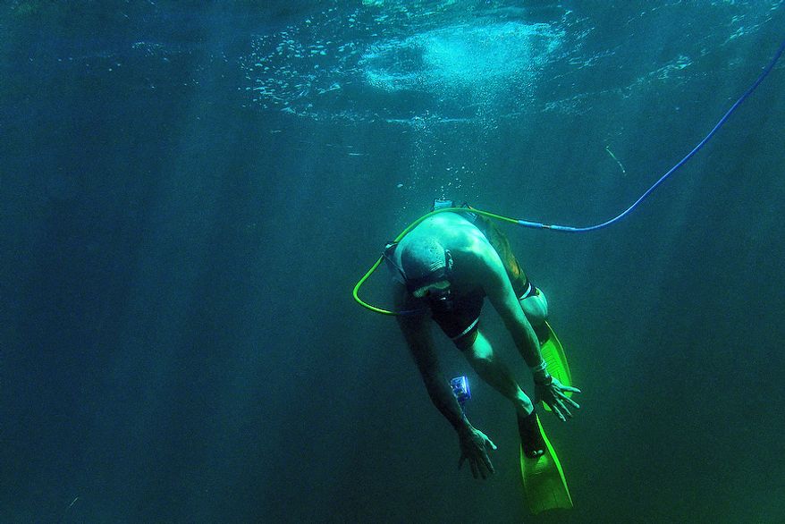 Paul Kuntne tries to dive down as he Snuba's for the first time off the coast of Roatan, Honduras on December 25, 2012. Snuba is an underwater breathing system. The air, however, instead of coming from tanks strapped to the diver's back, comes through a long hose from tanks on pontoon rafts on the surface. Paul retired from the Coast Guard where he served as part of the Presidential Honor Guard. (U.S. Air Force photo by Tech. Sgt. Jeremy T. Lock)