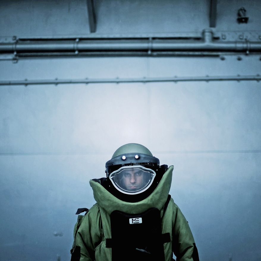 U.S. Air Force Explosive Ordnance Disposal (EOD) technician Staff Sgt. Salvatore DiGiacomo demonstrates use of the EOD 9 bomb suit. Air Force Sgt. Jeremy T. Lock has won top military photographer of the year honors seven times. (Sgt. Jeremy T. Lock)