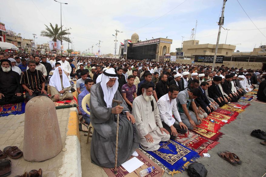 ** FILE ** Followers of radical Shiite cleric Muqtada al-Sadr attend Friday prayers in the Sadr City neighborhood in Baghdad, Iraq, Friday, March. 29, 2013. (AP Photo/Karim Kadim)