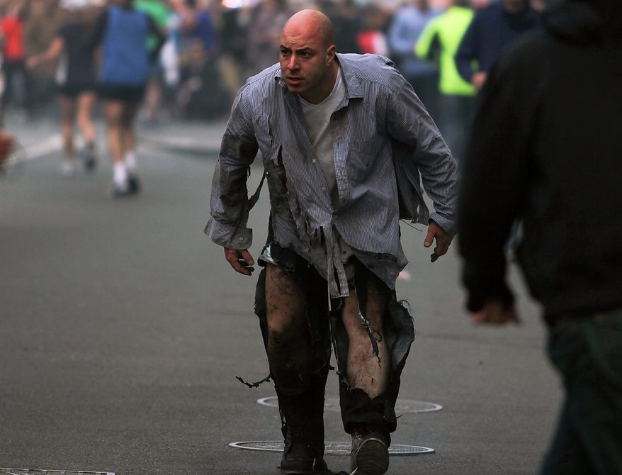 In this photo provided by The Daily Free Press and Kenshin Okubo, people react to an explosion at the 2013 Boston Marathon in Boston, Monday, April 15, 2013. Two explosions shattered the euphoria of the Boston Marathon finish line on Monday, sending authorities out on the course to carry off the injured while the stragglers were rerouted away from the smoking site of the blasts. (AP Photo/The Daily Free Press, Kenshin Okubo) MANDATORY CREDIT