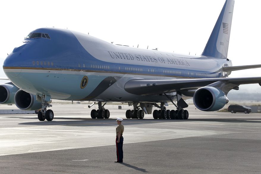 ** FILE ** A Marine officer stands watch as Air Force One, with President Obama on board, arrives at San Francisco International Airport outside San Francisco on Wednesday, April 3, 2013. (AP Photo/Tony Avelar)