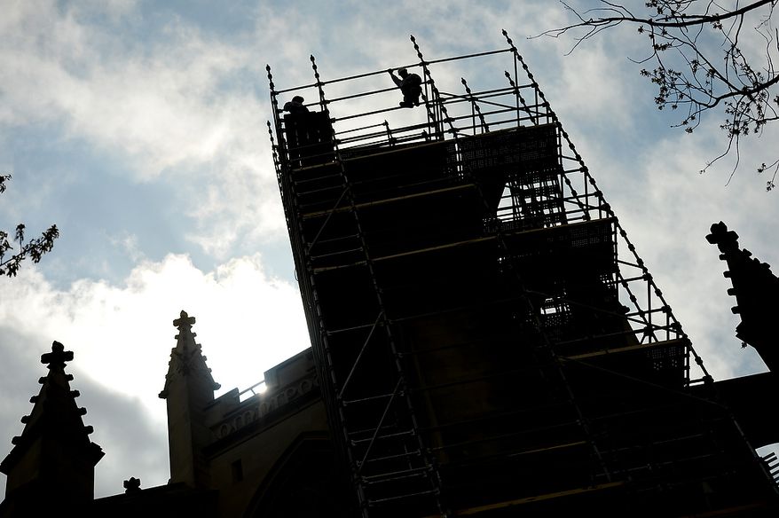 Cathedral Stone Mason/Stone Carvers Sean Callahan, left, and Andy Uhl, right, pose for a photo on the top of scaffolding constructed on the north east corner of the Apse, the eastern most point of the Washington National Cathedral, Washington, D.C., Monday, April 22, 2013. Repairs continue on the Washington National Cathedral, which sustained millions of dollars worth of damage from a 5.8 magnitude earthquake in August of 2011(Andrew Harnik/The Washington Times)