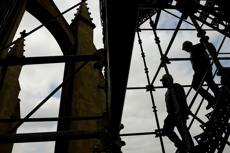 Cathedral Stone Mason/Stone Carvers Sean Callahan and Andy Uhl, right, pose for a photo as they make their way down scaffolding constructed on the north east corner of the Apse, the eastern most point of the Washington National Cathedral, Washington, D.C., Monday, April 22, 2013. Repairs continue on the Washington National Cathedral, which sustained millions of dollars worth of damage from a 5.8 magnitude earthquake in August of 2011(Andrew Harnik/The Washington Times)