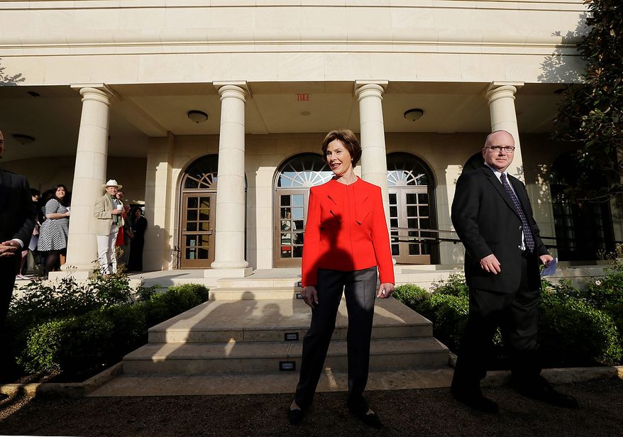 Former first lady Laura Bush and Alan Lowe, director of the library and museum enter a replica of the White House rose garden during a tour of the George W. Bush Presidential Center Wednesday, April 24, 2013, in Dallas. More than 8,000 people are expected to attend the invitation-only dedication of the center, Thursday, April 25, which will house the presidential library and museum along with the 43rd presidentís policy institute. It opens to the public on May 1. (AP Photo/David J. Phillip)
