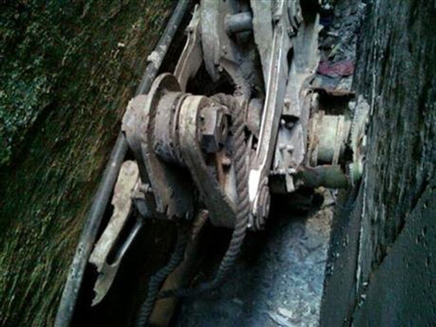 A piece of landing gear that authorities believe belongs to one of the airliners that crashed into the World Trade Center on Sept. 11, 2001 was found wedged between a mosque and another building, in New York, on Friday, April 26, 2013. Police say the medical examiner's office will complete a health and safety evaluation to determine whether to sift the soil around the buildings for possible human remains. (AP Photo/New York City Police Department)