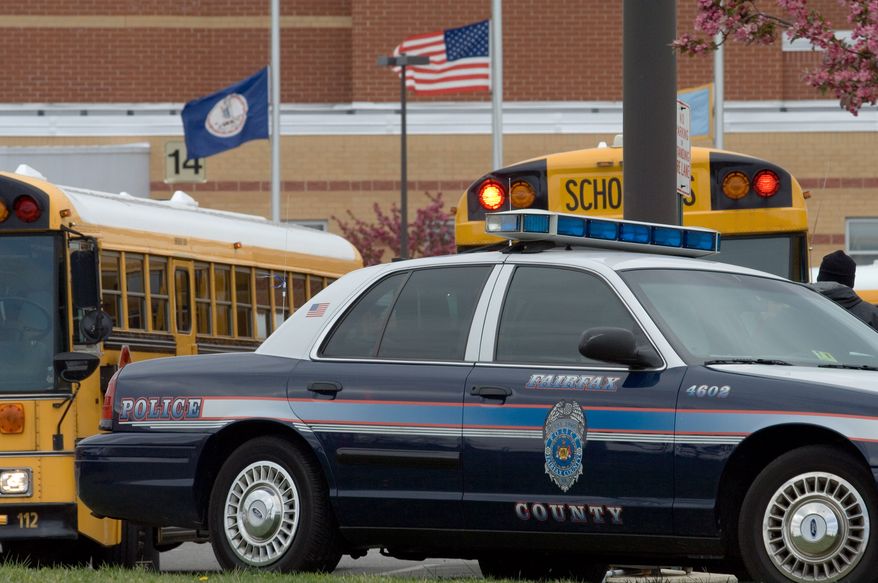 **FILE** A Fairfax County Police vehicle sits at the entrance to Westfield High School in Chantilly, Va., on April 17, 2007. (Associated Press)