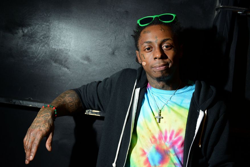 ** FILE ** Recording artist Lil Wayne meets fans and celebrates his contemporary street wear apparel brand TRUKFIT at his hometown Macy's in New Orleans on Friday, Feb. 1, 2013. (Jordan Strauss/Invision/AP)
