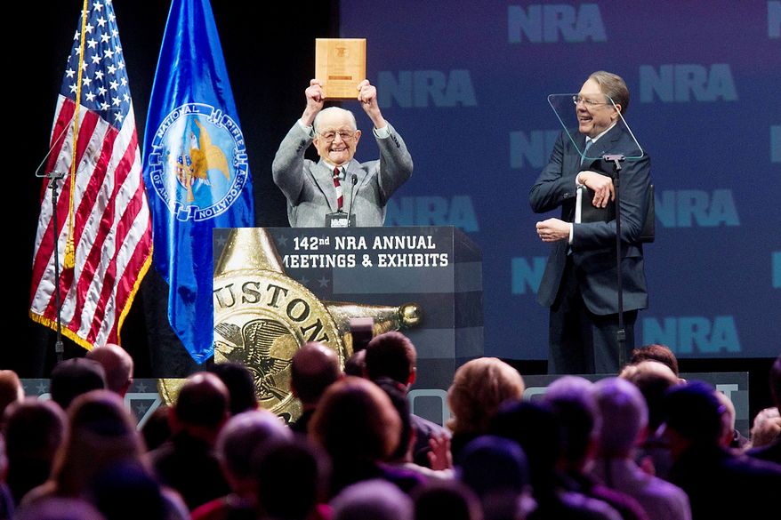 Born in 1917, the oldest life NRA member in attendance, Wayne Burd, holds up the plaque he received for being a member since 1938 next to Wayne LaPierre, executive vice president of the NRA during the NRA Annual Meeting of Members at the National Rifle Association's 142 Annual Meetings and Exhibits in the George R. Brown Convention Center Saturday, May 4, 2013, in Houston. National Rifle Association leaders told members Saturday that the fight against gun control legislation is far from over, with battles yet to come in Congress and next year's midterm elections, but they vowed that none in the organization will ever have to surrender their weapons. (AP Photo/Houston Chronicle, Johnny Hanson)