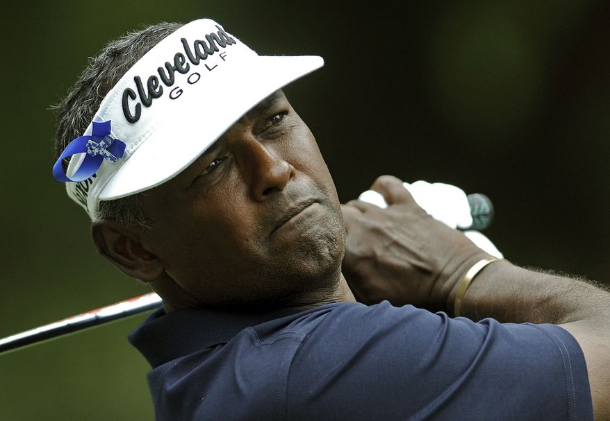 FILE - In this April 19, 2013, file photo, Vijay Singh, of Fiji, tees off on the ninth hole while wearing an "Els for Autism" ribbon in his visor during the second round of the RBC Heritage golf tournament in Hilton Head Island, S.C. Singh no longer faces any sanction for using deer antler spray. The PGA Tour said Tuesday, April 30, 2013, that it was dropping the case against the three-time major champion. Tour commissioner Tim Finchem says new information from the World Anti-Doping Agency indicates that using deer antler spray is no longer considered prohibited. (AP Photo/Stephen Morton, File)