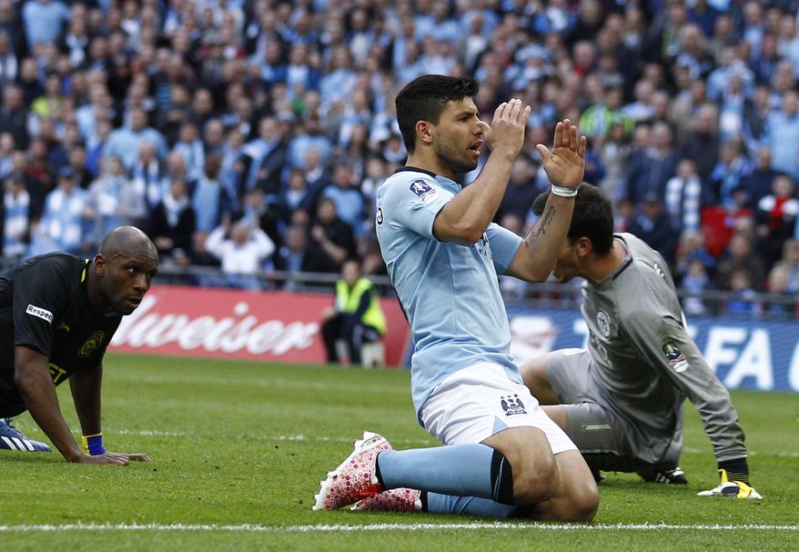 Manchester City's Sergio Aguero, center, reacts to his missed chance to score against Wigan Athletic during their English FA Cup final soccer match at Wembley Stadium, London, Saturday, May 11, 2013. (AP Photo/Jon Super)