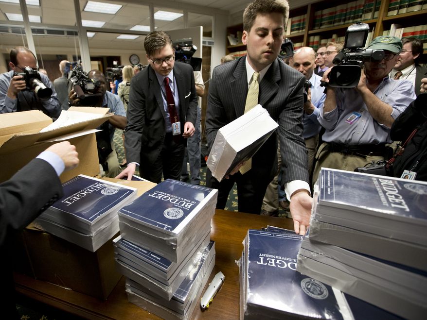 **FILE** Copies of President Obama's budget plan for fiscal year 2014 are distributed to Senate staff on Capitol Hill in Washington on April 10, 2013. (Associated Press)