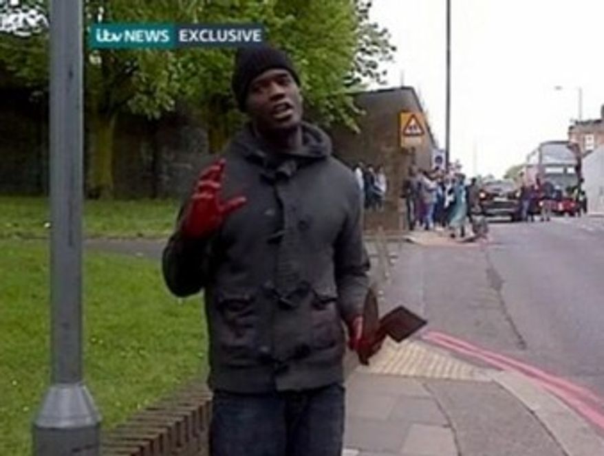 A man stands in a London street after allegedly screaming, 'Allahu Akbar,' and killing a man in broad daylight. (ITV news screenshot)