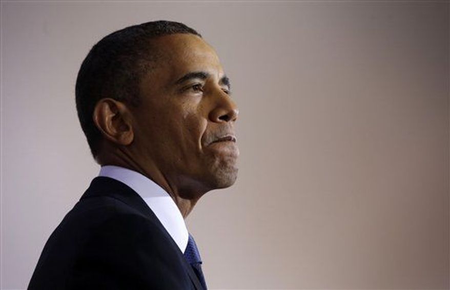 President Obama pauses while talking about national security on Thursday, May 23, 2013, at the National Defense University at Fort McNair in Washington. He was interrupted multiple times by hecklers. (AP Photo/Pablo Martinez Monsivais)