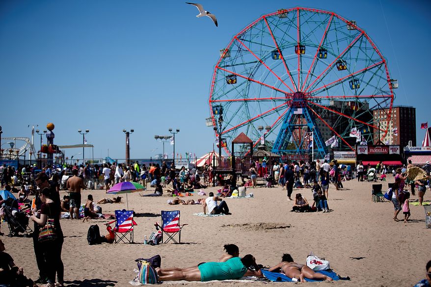 Two American flag-themed beach chairs rest on the sand on Memorial Day at Coney Island, Monday, May 27, 2013, in New York. Despite cool weather and cold water, thousands of visitors took to the sand and the boardwalk. (AP Photo/John Minchillo)