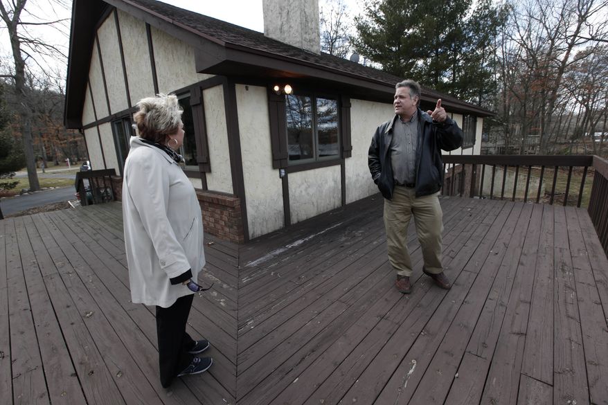 Sam and Liz Weidner of Hudsonville, Mich., view a home for sale in Cascade Township, Mich., on Tuesday, April 2, 2013. (AP Photo/Paul Sancya)