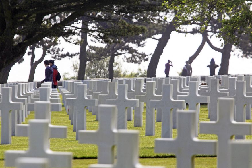 ** FILE ** Visitors walk among the graves at the Normandy American Cemetery overlooking Omaha Beach in Colleville-sur-Mer, France, on Thursday, June 6, 2013, the 69th anniversary of D-Day. (AP Photo/Remy de la Mauviniere)