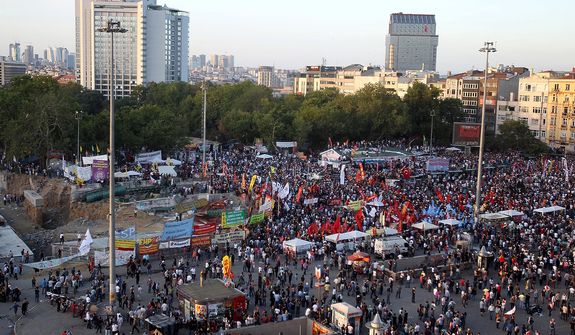 Protesters gather during a new rally after clashes at Taksim Square in Istanbul on Tuesday, June 11, 2013. Hundreds of riot police overran improvised barricades on the square and fired tear gas, rubber bullets and water cannon in running battles with protesters who have been occupying the area for more than a week. (AP Photo/Thanassis Stavrakis)