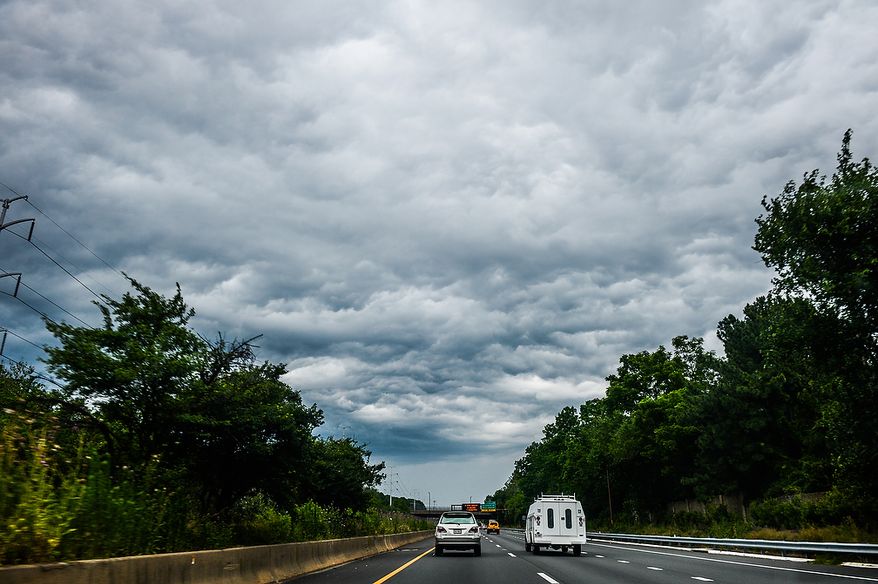 Morning storm clouds can be seen on Interstate 66, Arlington, Va., Thursday, June 13, 2013. (Andrew Harnik/The Washington Times)