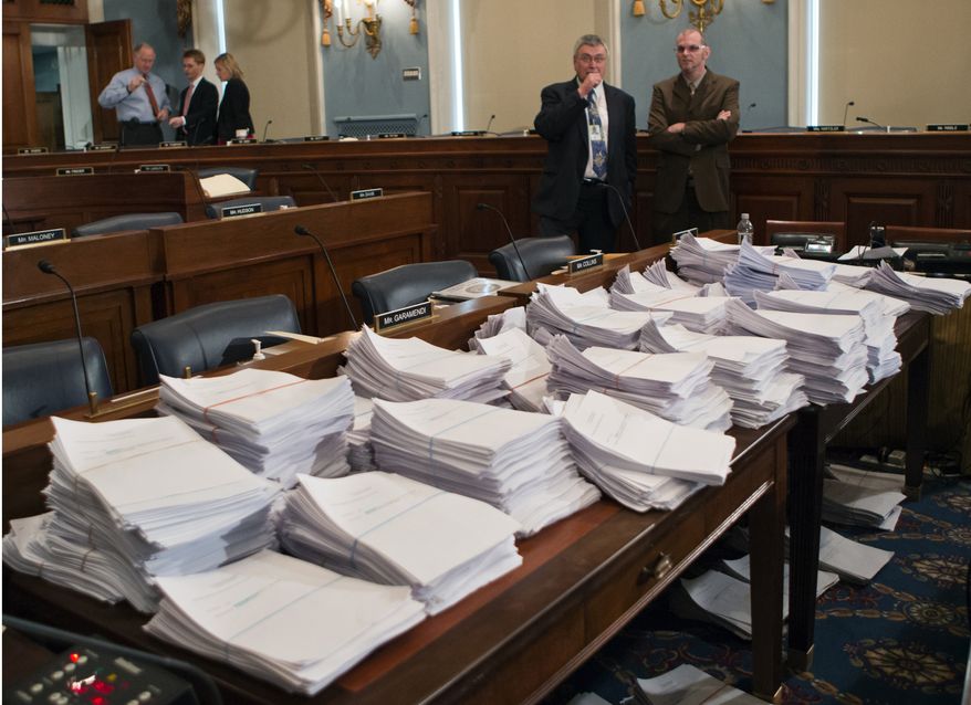 **FILE** Stacks of paperwork await members of the House Agriculture Committee on Capitol Hill in Washington on May 15, 2013, as it meets to consider proposals to the 2013 Farm Bill. (Associated Press)