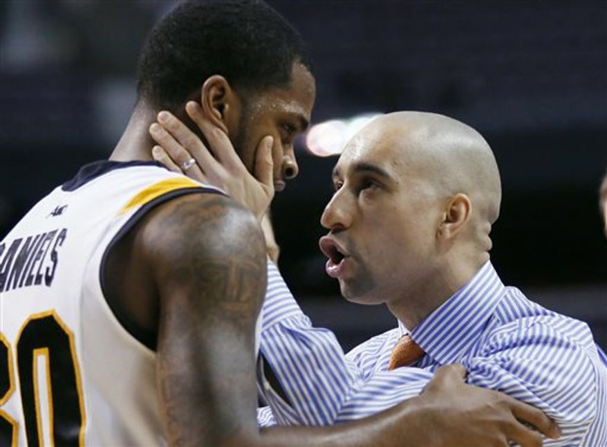FILE - In this March 21, 2013 file photo, Virginia Commonwealth coach Shaka Smart, right, talks to guard Troy Daniels during the closing minutes of the team's 88-42 win over Akron in a second-round game of the NCAA men's college basketball tournament in Auburn Hills, Mich. Two years removed from leading VCU to the Final Four and becoming one of the biggest rock stars in college basketball, Smart has gone through his third consecutive offseason where he was mentioned for big job after big job. (AP Photo/Duane Burleson, File)