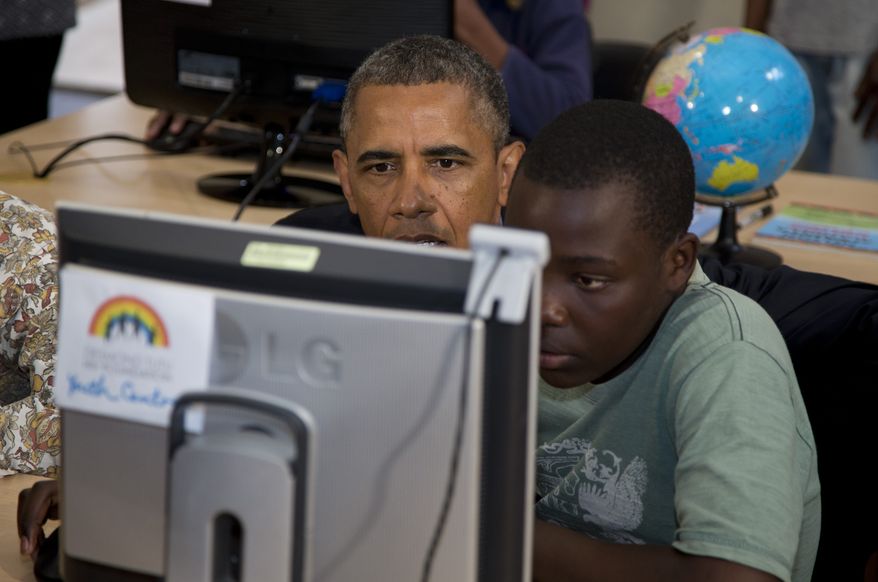 President Obama looks at a project prepared by students at the Demond Tutu HIV Foundation Youth Center during his visit to Cape Town, South Africa, on June 30, 2013. (Associated Press)