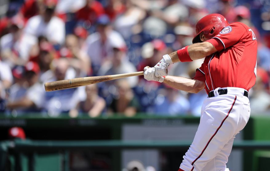Washington Nationals' Ryan Zimmerman follows through on his grand slam against the San Diego Padres during the third inning of a baseball game on Sunday, July 7, 2013, in Washington. (AP Photo/Nick Wass)