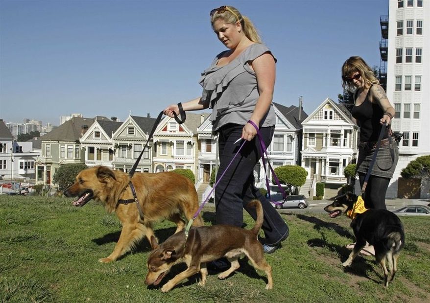 ** FILE ** Antonia Tamer, left, and a woman who identified herself as "Cheyenne" walk their dogs in San Francisco. (Associated Press)