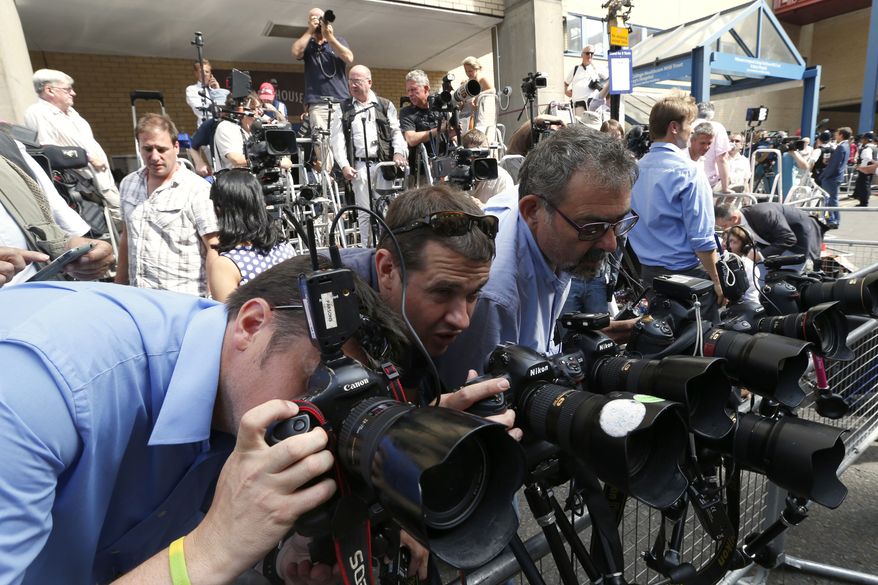 Photographers adjust their camera's outside St. Mary's Hospital exclusive Lindo Wing in London, Monday, July 22, 2013. Buckingham Palace officials say Prince William's wife, Kate, has been admitted to the hospital in the early stages of labour. Royal officials said that Kate traveled by car to St. Mary's Hospital in central London. Kate, also known as the Duchess of Cambridge, is expected to give birth in the private Lindo Wing of the hospital, where Princess Diana gave birth to William and his younger brother, Prince Harry.The baby will be third in line for the British throne, behind Prince Charles and William, and is anticipated eventually to become king or queen. (AP Photo/Lefteris Pitarakis)