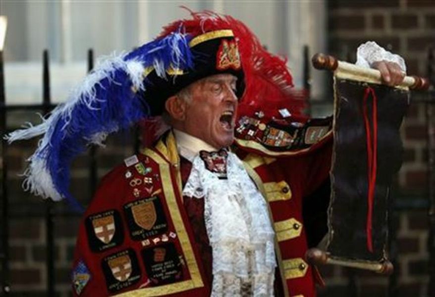 ** FILE ** Tony Appleton, a town crier, announces the birth of the royal baby, outside St. Mary's Hospital exclusive Lindo Wing in London, July 22, 2013. Well-wishers waiting outside St. Mary's Hospital in London might have been forgiven for thinking Appleton had the royal seal of approval. Appleton is in fact a crier, but in Romford, a commuter town just east of London, and in Bury St. Edmunds, a market town in southeastern England, not Buckingham Palace. (Associated Press)