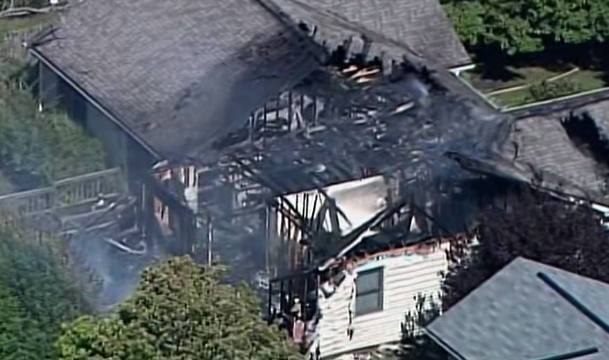 In this frame grab from video provided by Chopper 8, WISH TV, smoke rises from a house in Columbus, Ind., after a small plane crashed into the home. (AP Photo/Chopper 8, WISH TV)