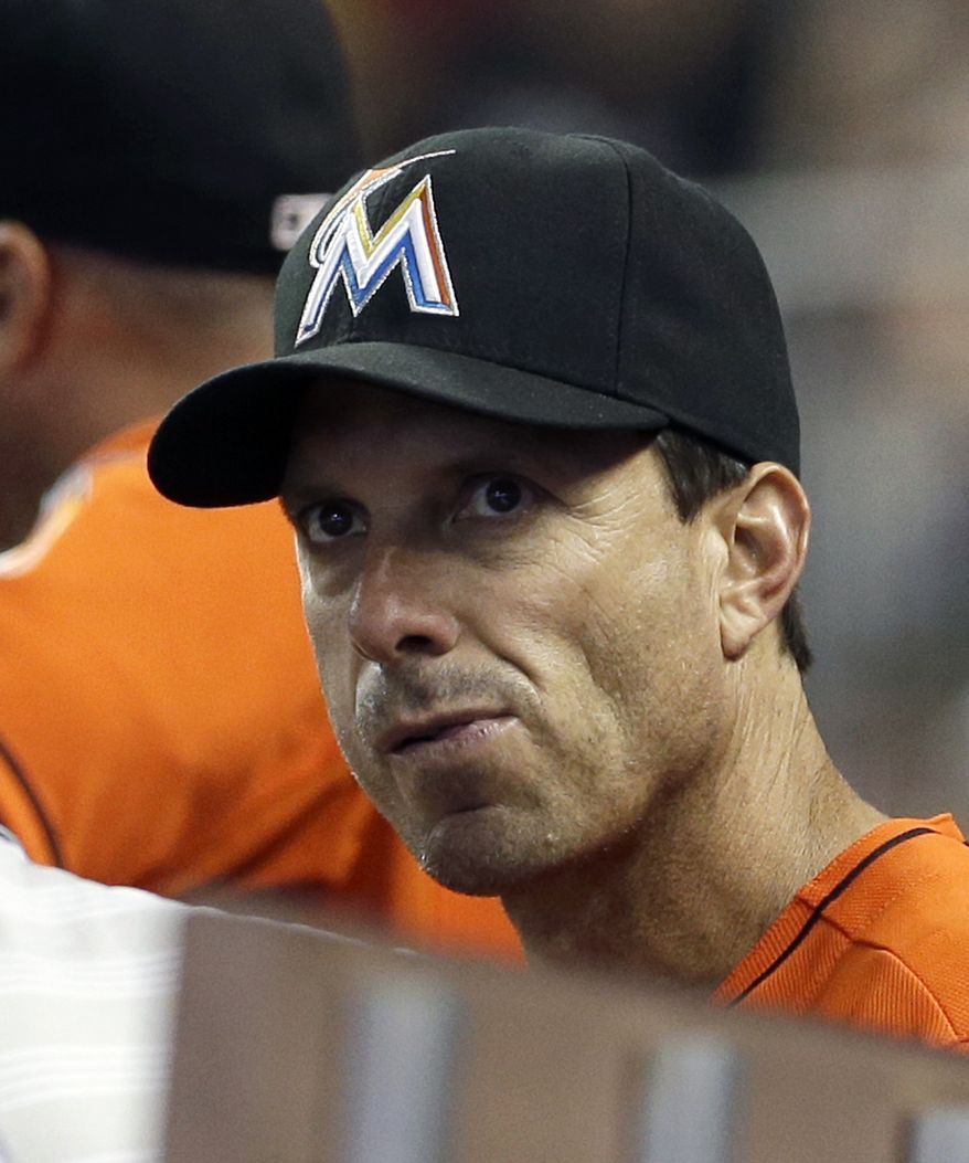 Miami Marlins hitting coach Tino Martinez looks from the dugout during a baseball game against the Pittsburgh Pirates in Miami, Sunday, July 28, 2013. Martinez has resigned after players complained he verbally abused them. (AP Photo/Alan Diaz)