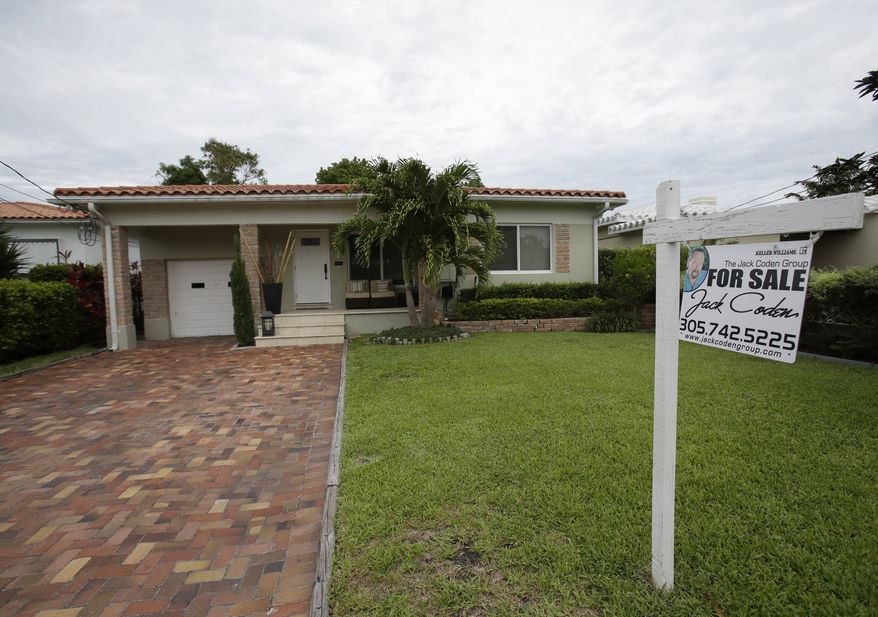 ** FILE ** In this Tuesday, May 28, 2013, photo, a single family home is shown for sale in Surfside, Fla. (AP Photo/Wilfredo Lee)